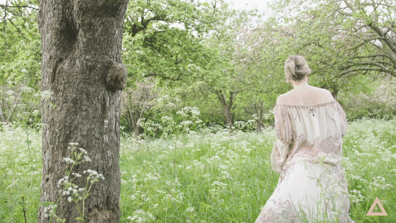 rebecca campbell walking through wild flower field